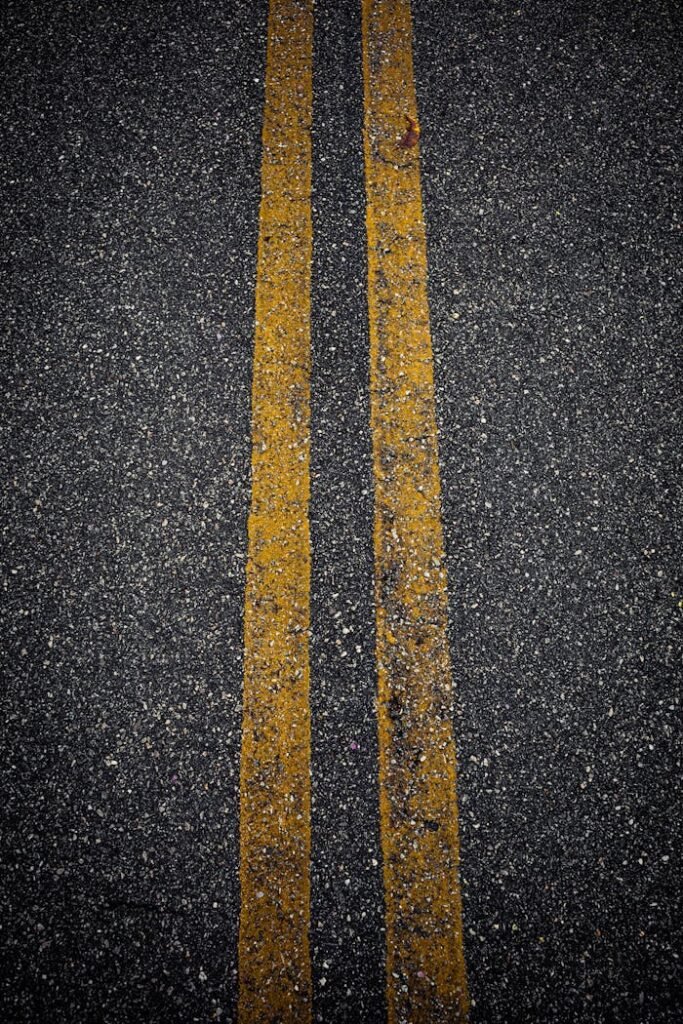 A close up of a road with yellow lines